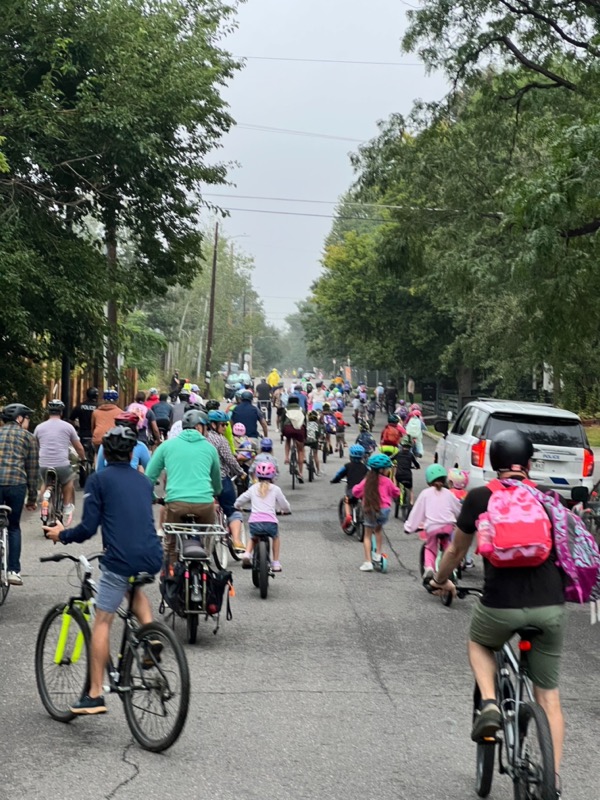 A group of cyclists riding together on a Denver street